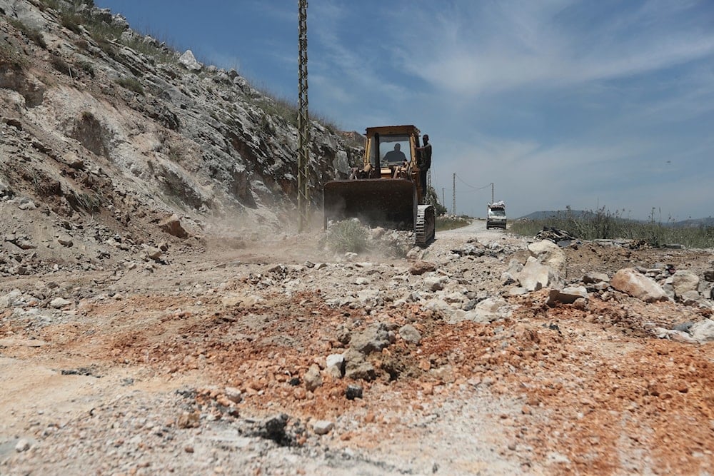 A bulldozer closes a crater following Israeli airstrikes that targeted hilltops near Nabatieh town, south Lebanon, on May 8, 2025. (AP Photo/Mohammed Zaatari)