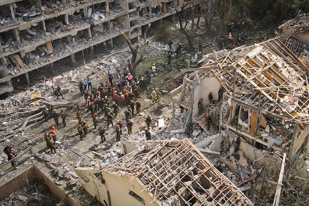 Firefighters, rescue workers and military work at the site of a direct missile strike launched from Iran in Tel Aviv, Israel, on June 22, 2025. (AP Photo/Oded Balilty)
