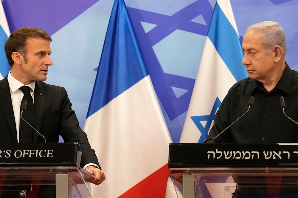 Israeli Prime Minister Benjamin Netanyahu, right, and French President Emmanuel Macron attend a joint press conference in Jerusalem, Tuesday, Oct. 24, 2023 (AP)