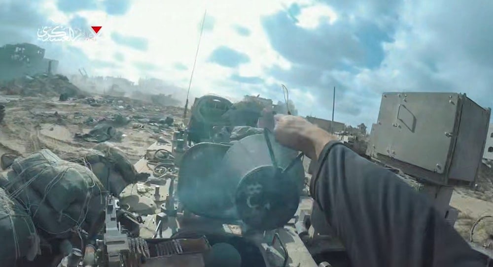 An Al-Qassam Fighter plants a explosive device in an Israeli Puma APC as part of a complex ambush, Gaza, Occupied Palestine, June 24, 2025 (Screengrab, Al Qassam Military Media)