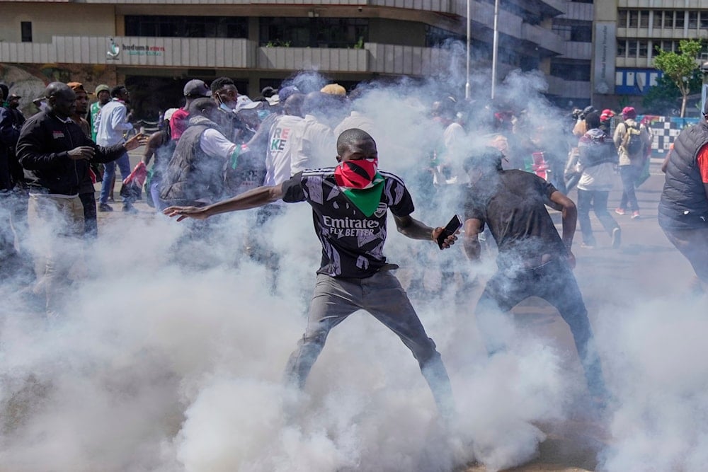 Protesters scatter as police fire teargas at them during a demonstration on the one-year anniversary of deadly anti-tax demonstrations in downtown Nairobi, Kenya, Wednesday, June 25, 2025 (AP)