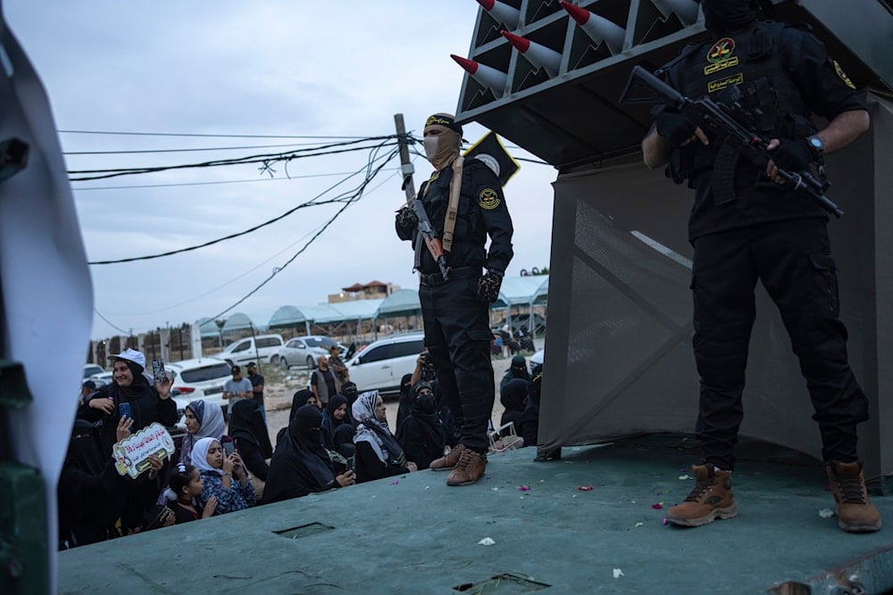 Palestinian fighters from the Islamic Jihad militant group riding on a truck with weaponry on display take part in an anti-Israel parade marking the 36th anniversary of the movement's founding, in Gaza City, Wednesday, Oct. 4, 2023 (AP)