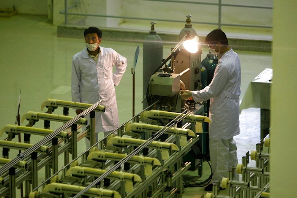 In this April 9, 2009, file picture, Iranian technicians work at a new facility producing uranium fuel for a planned heavy-water nuclear reactor, just outside the city of Isfahan, 255 miles (410 kilometers) south of the capital Tehran (AP)