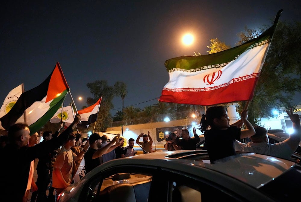 Protesters gather in front of the Iranian Embassy carry Iranian flags in celebration of ceasefire between Iran and Israel, in Baghdad, Iraq, Tuesday, June 24, 2025 (AP)