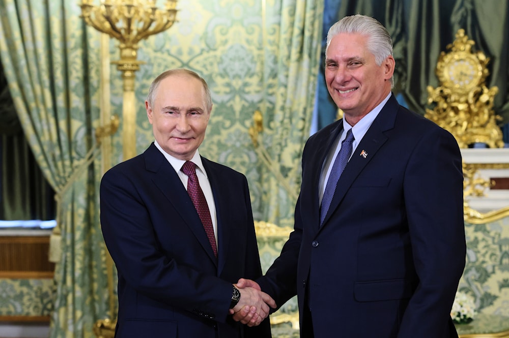 Russian President Vladimir Putin and Cuban President Miguel Diaz-Canel shake hands during a meeting at the Kremlin in Moscow, Russia, Wednesday, May 7, 2025 (AP)