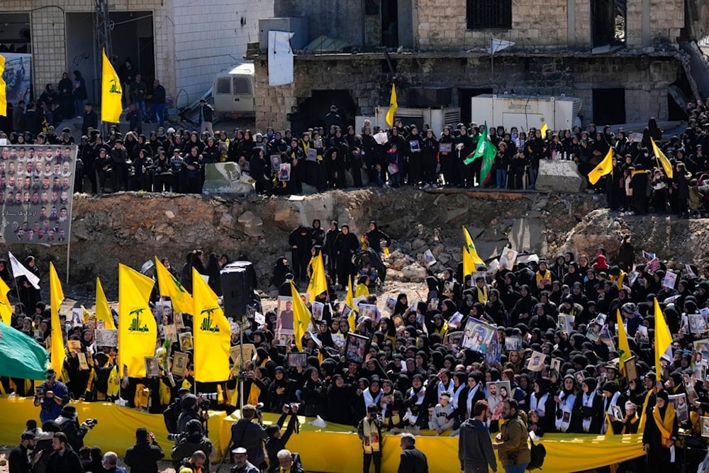 Mourners gather to bury the bodies of nearly 100 Lebanese people killed during the war waged by the Israeli occupation on Lebanon in the village of Aitaroun, Lebanon, Friday, February 28, 2025 (AP)