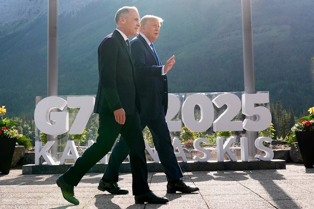 Canada's Prime Minister Mark Carney walks with President Donald Trump after a group photo at the G7 Summit, Monday, June 16, 2025, in Kananaskis, Canada (AP)