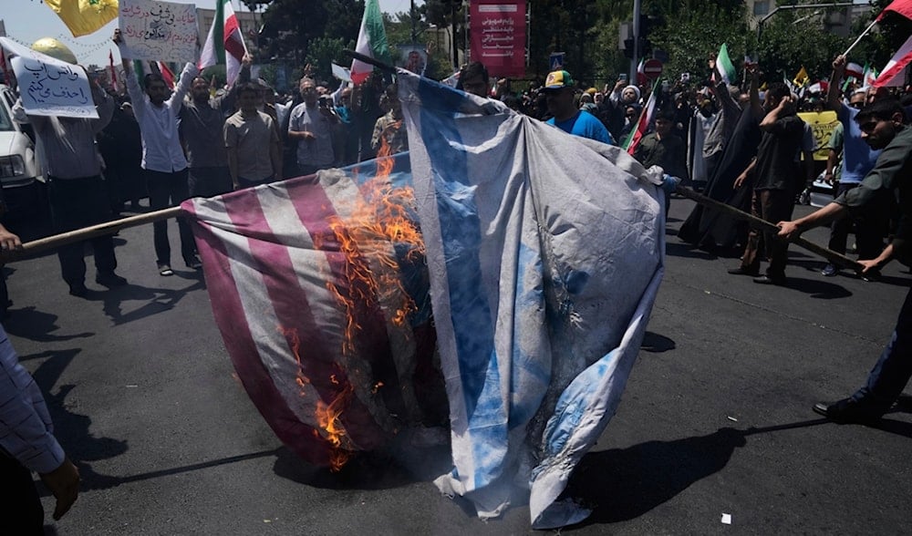 Iranian protestors burn Israeli and U.S. flags during a protest to condemn Israeli attacks on multiple cities across Iran, after the Friday prayers ceremony in Tehran, Iran, Friday, June 20, 2025. (AP)