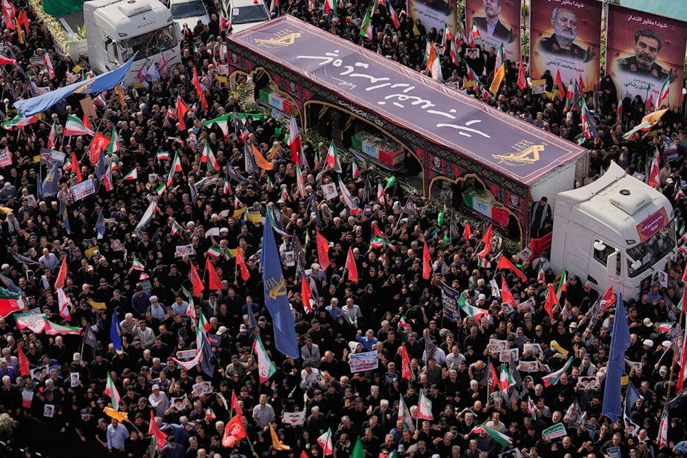 Mourners gather around the flag-draped coffins of the Iranian armed forces generals, nuclear scientists and their family members on the trucks, who were killed in Israeli strikes, during their funeral ceremony in Tehran, Iran, Saturday, June 28, 2025. (AP)