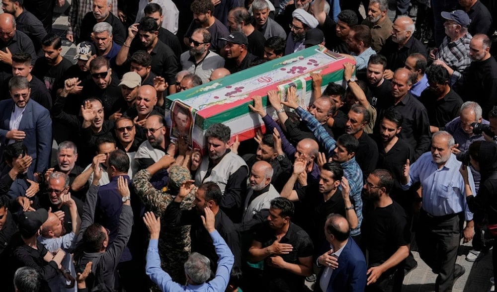 Mourners carry the flag-draped coffin of Mahan Setareh, a member of the paramilitary Basij force who was killed in Israeli attacks, during his funeral ceremony in Tehran, Iran, Thursday, June 26, 2025. (AP)
