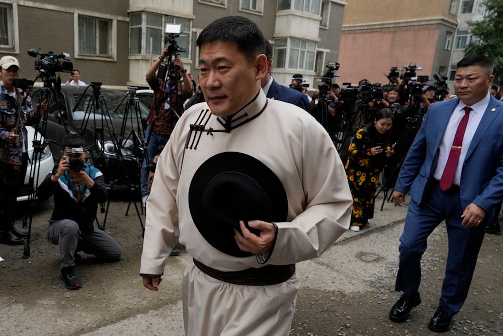 vMongolian Prime Minister Oyun-Erdene Luvsannamsrai walks past journalists as he arrives to vote at a polling station in Ulaanbataar, Mongolia, Friday, June 28, 2024 (AP)