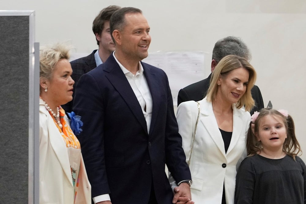 Presidential candidate Karol Nawrocki, second left, arrives at a polling station with family members during the presidential election runoff in Warsaw, Poland, Sunday, June 1, 2025 (AP)