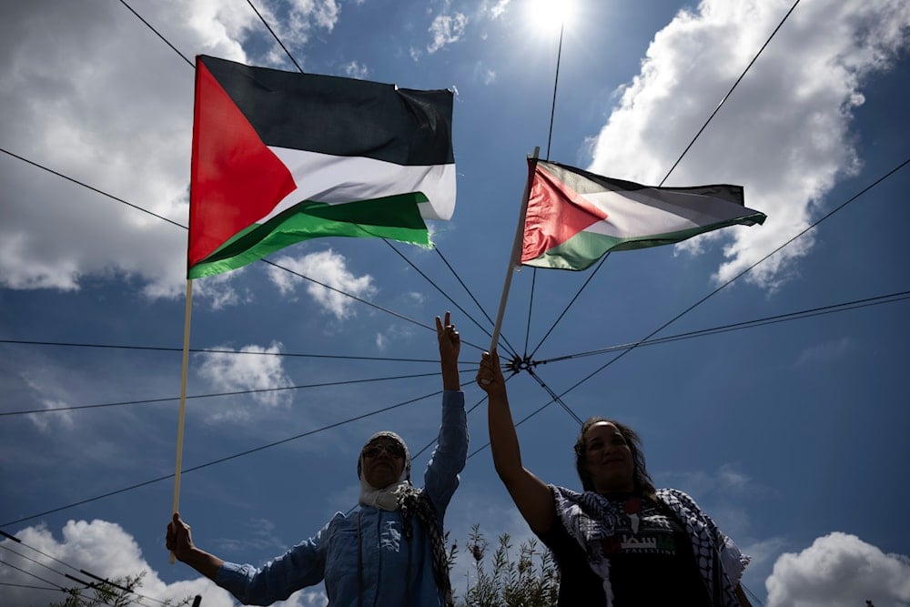 Protesters wave Palestinian flags outside the Israeli embassy, during a demonstration in support of Palestinians in Gaza, in Athens, Greece, Saturday, May 31, 2025 (AP)