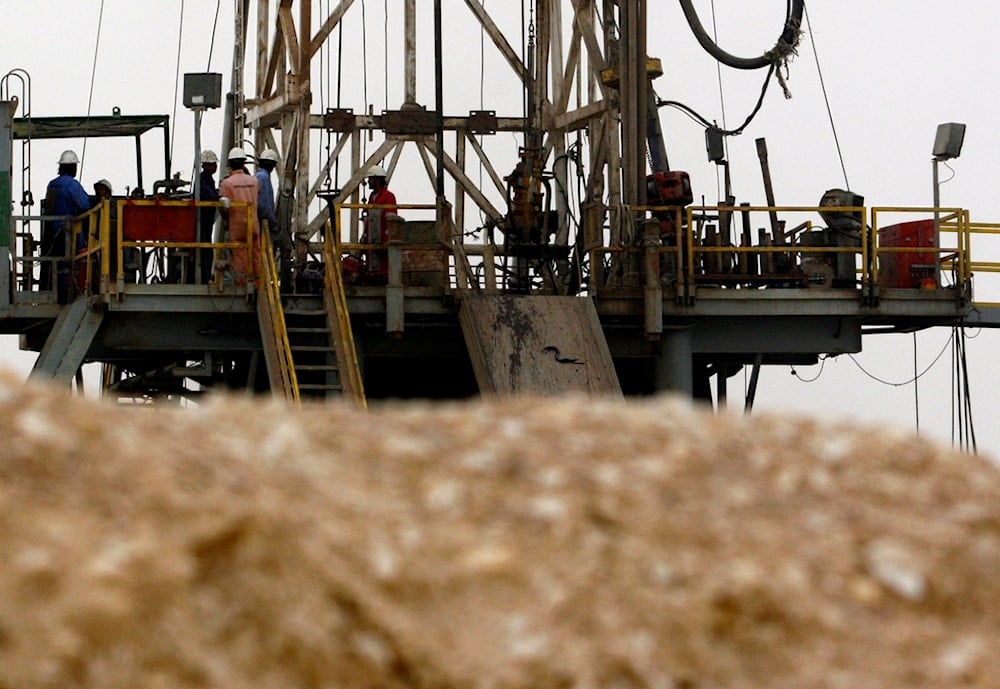 Oil workers stand on a new rig Tuesday, June 17, 2008, in the Sakhir, Bahrain (AP)