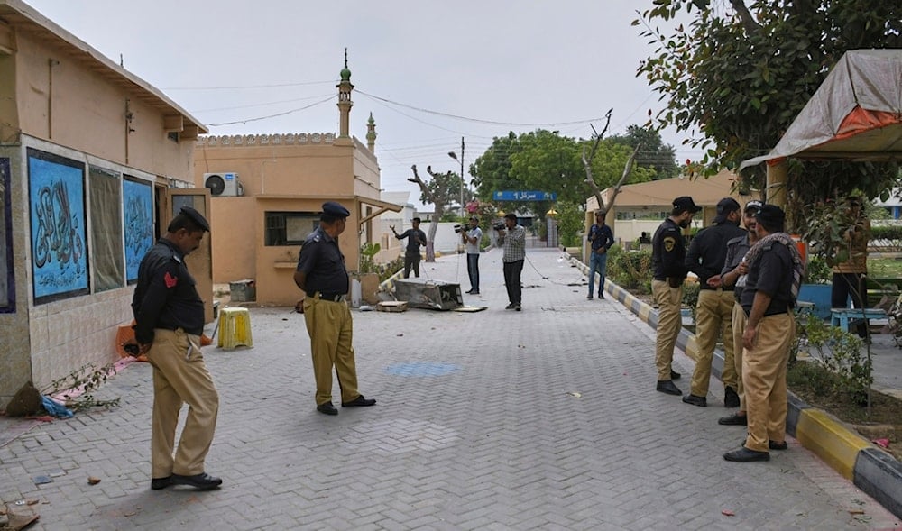Police officer stand guard as members of media film inside the premises of the district Malir prison from where more than 100 inmates escaped overnight, in Karachi, Pakistan, Tuesday, June 3, 2025. (AP)