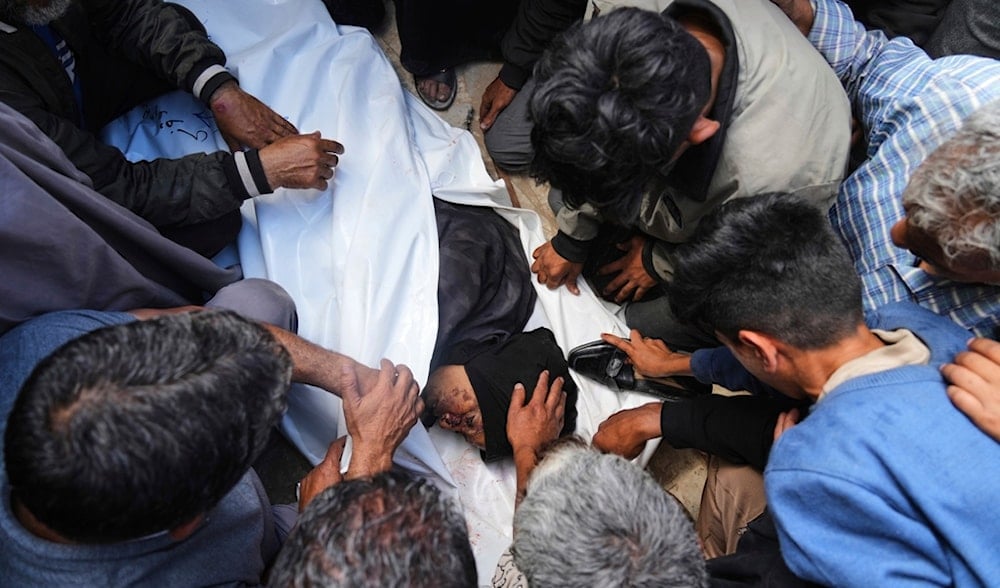 Palestinians mourn over the body of Reem Al-Akhras who was killed while heading to a Gaza aid hub, during her funeral at the Nasser Hospital in Khan Younis, southern Gaza Strip, Tuesday, June 3, 2025. (AP)
