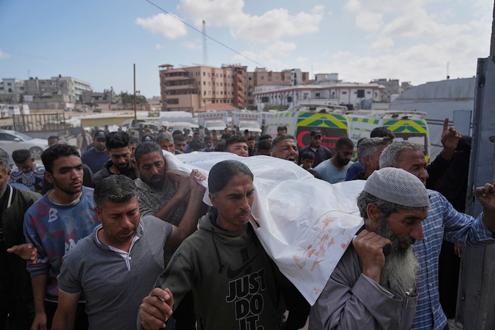 Palestinians carry the body of Reem Al-Akhras who was killed while heading to a Gaza aid hub, during her funeral in Khan Younis, southern Gaza Strip, Tuesday, June 3, 2025 (AP)