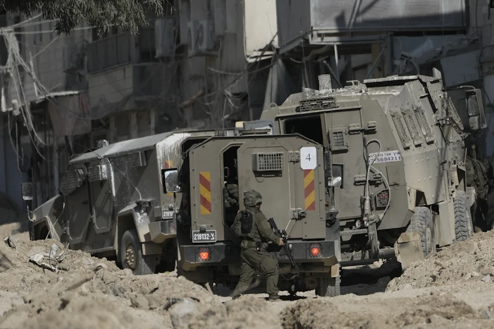 Members of Israeli occupation forces patrol a street during a raid in the West Bank refugee camp of Nur Shams. Thursday August 29, 2024. (AP)