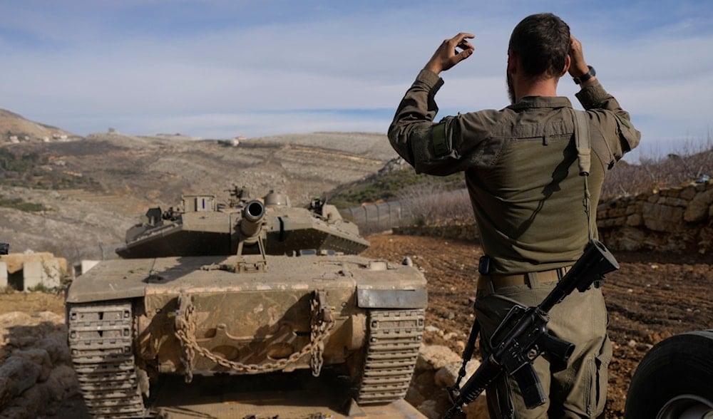 An Israeli soldier load a tank, next to the security fence near the so-called Alpha Line that separates the Israeli-annexed Golan Heights from Syria, in the town of Majdal Shams, Wednesday, Dec. 11, 2024. (AP)