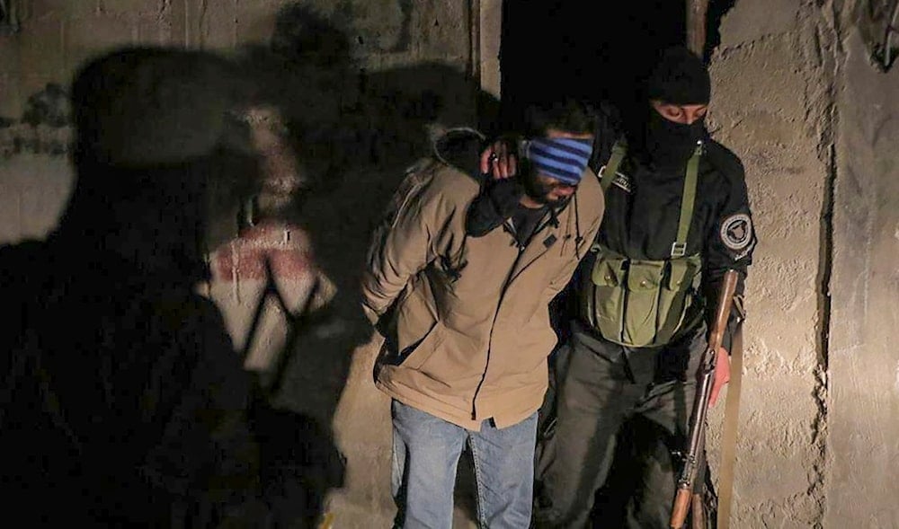 In this photo released by Syrian State TV, one of four suspects arrested in connection with an alleged plot by ISIS is escorted by security officers in Damascus, Syria, Saturday, Jan. 11, 2025. (AP)