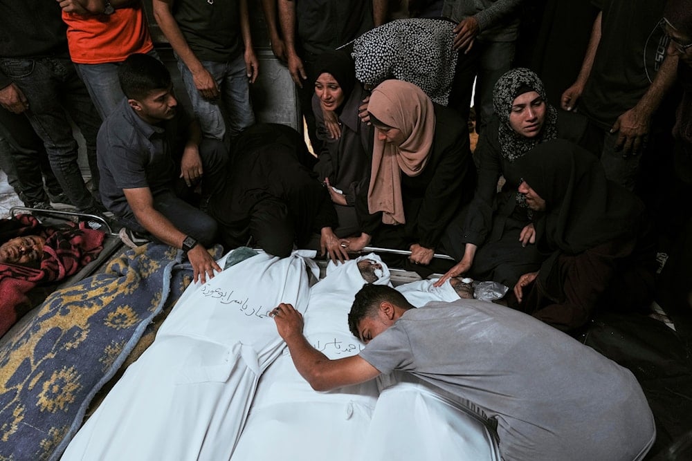 Palestinians mourn over the bodies of their relatives who were killed in an Israeli strike on Gaza at Al-Shifa Hospital in Gaza City, Wednesday, June 4, 2025. (AP)