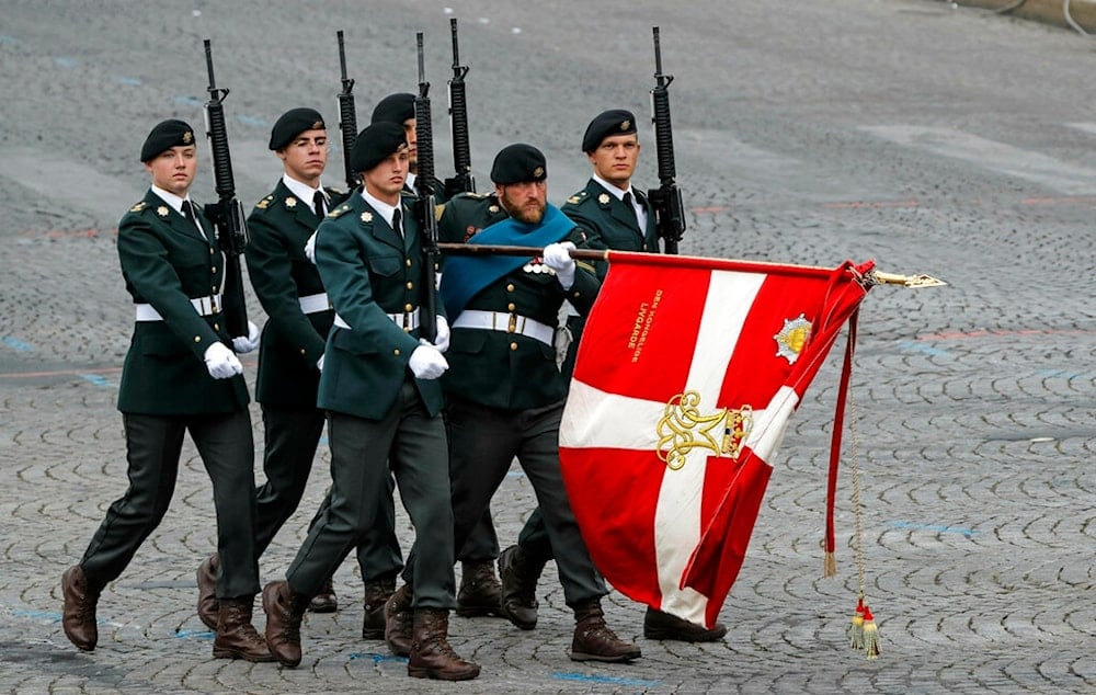 Danish soldiers march on the Champs-Elysees avenue during the Bastille Day parade in Paris, France, Sunday July 14, 2019. (AP Photo/Michel Euler)