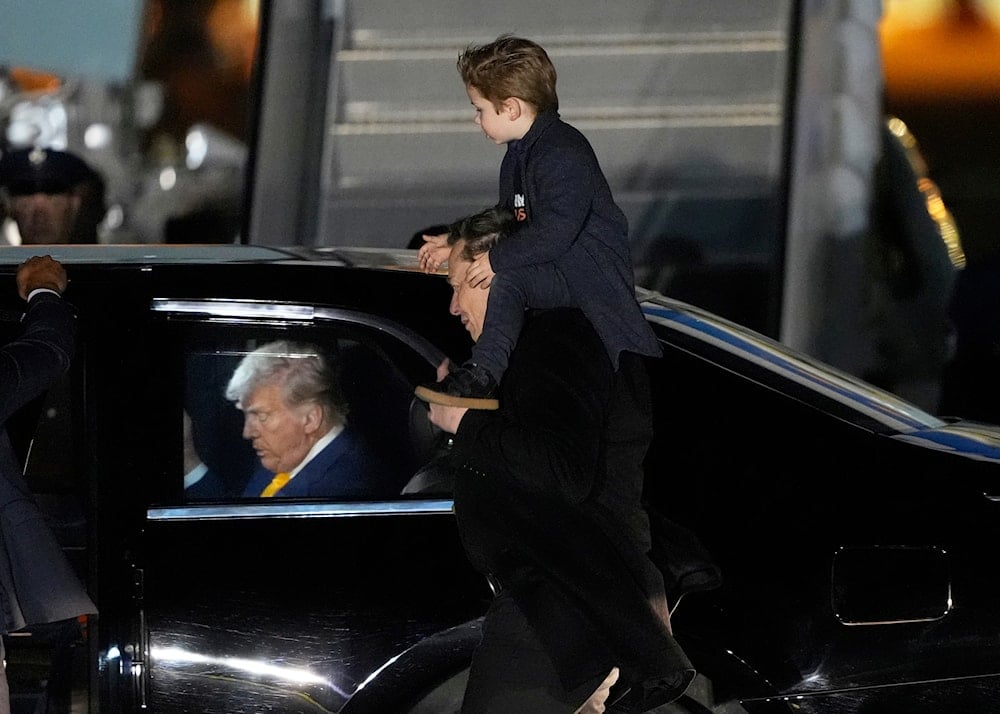 FILE - Elon Musk carries his son X Æ A-Xii as they arrives on Air Force One with President Donald Trump, left, at Miami International Airport, April 12, 2025, in Miami, Fla. (AP)