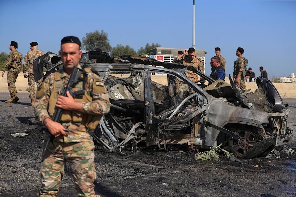 Lebanese army members gather near a charred car that was hit by an Israeli strike, in the southern coastal town of Ghazieh, Lebanon, Friday, April 18, 2025. (AP)