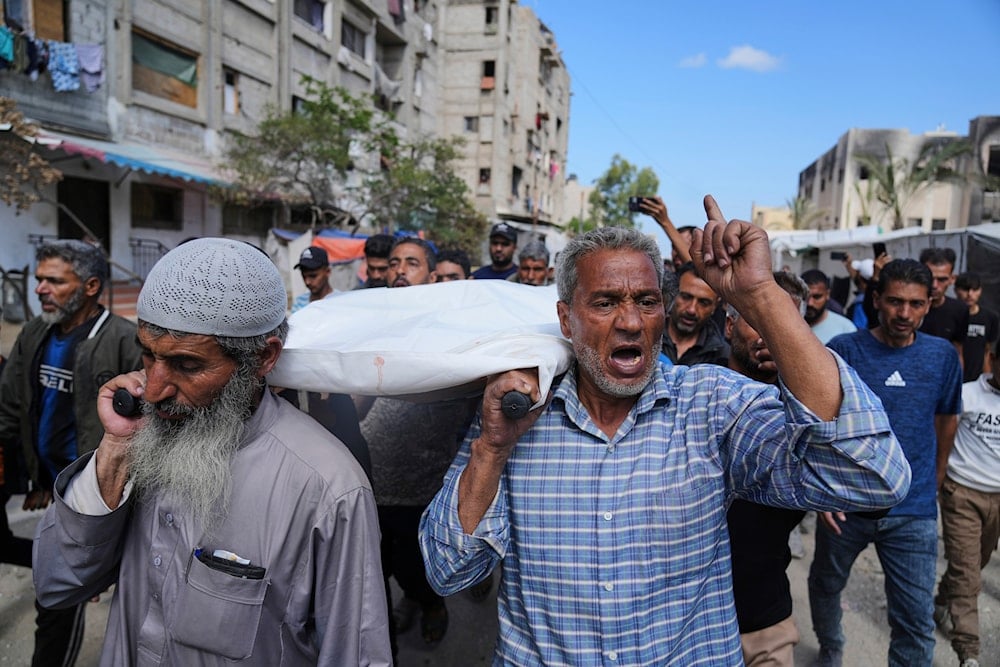 Palestinians carry Reem Al-Akhras, who was killed while heading to an aid distribution hub, during her funeral in Khan Younis, Gaza Strip, Tuesday, June 3, 2025 (AP)