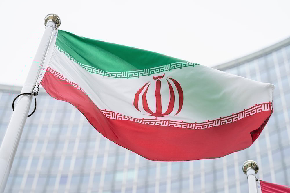 the flag of Iran waves in front of the the International Center building with the headquarters of the International Atomic Energy Agency, IAEA, in Vienna, Austria, on May 24, 2021. (AP)