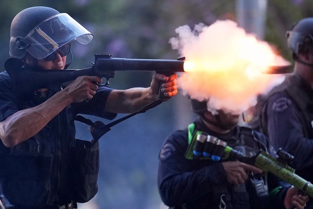 A police officer fires a soft round near the metropolitan detention center of downtown Los Angeles, Sunday, June 8, 2025, following last night's immigration raid protest (AP)