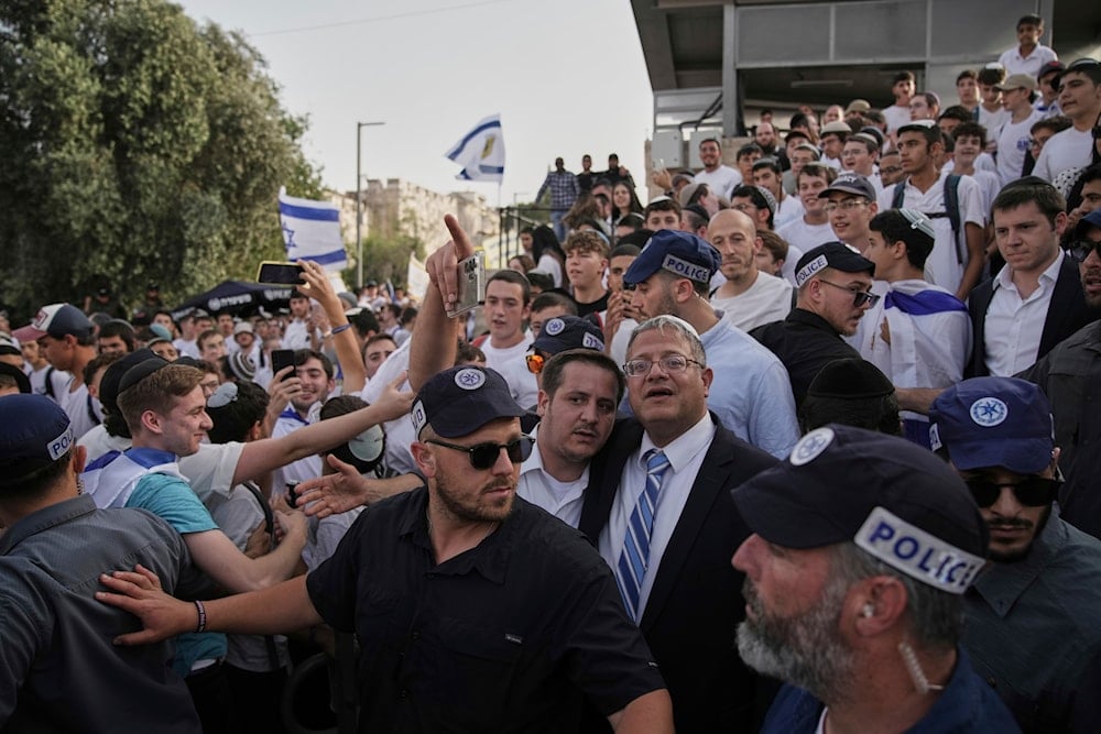 Israel's far-right National Security Minister, Itamar Ben-Gvir, center, participates in march, in al-Quds, Occupied Palestine, Monday, May 26, 2025 (AP)