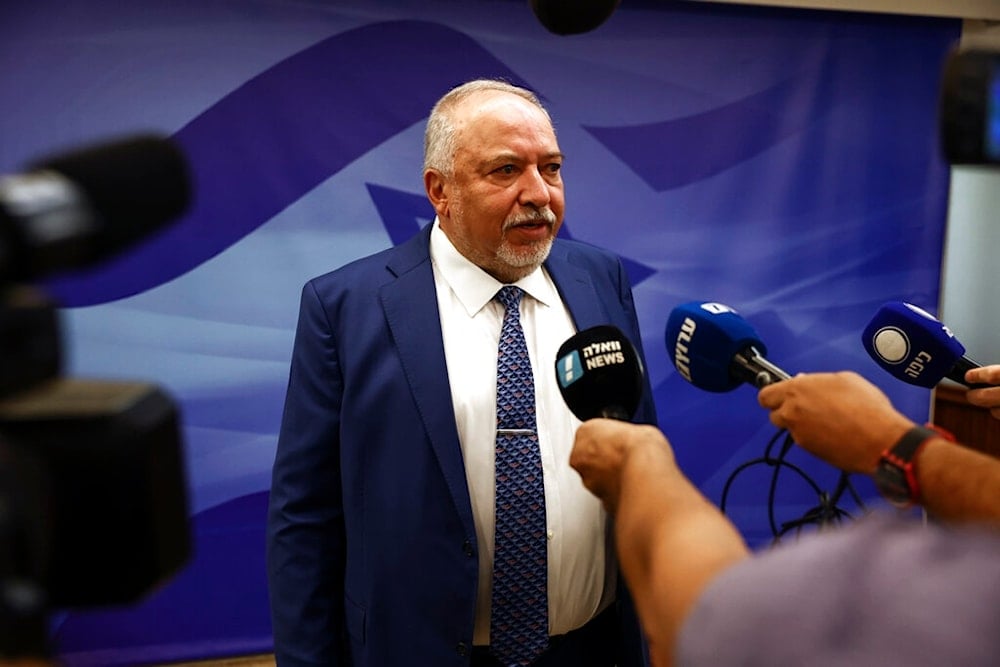 Then-Israeli Finance Minister Avigdor Lieberman speaks to journalist at the weekly cabinet meeting, in occupied al-Quds, occupied Palestine, Sunday, September 11, 2022. (Pool via AP)