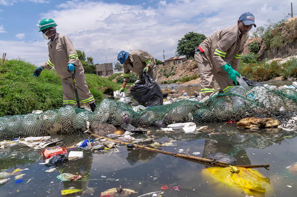 FILE - Alexandra Water Warriors volunteers cleanup the Juksei river in the heart of Alexandra township from plastic pollution in Johannesburg, South Africa, Nov. 27, 2024. (AP)