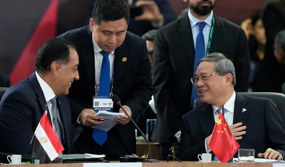 Egypt's Prime Minister Mustafa Madbouly, left, speaks with China's Premier Li Qiang, during the 17th annual BRICS summit in Rio de Janeiro, Brazil, Monday, July 7, 2025. (AP)