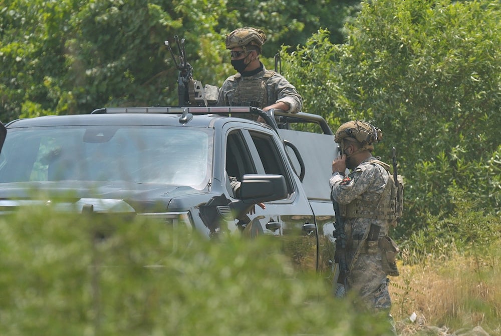 Forces of the regional Kurdish administration secure the area of the Jasana Cave ahead of a symbolic disarmament ceremony by the separatist PKK group as part of the peace process with Turkey, in Sulaymaniyah governorate, Iraq, Friday, July 11, 2025 (AP)