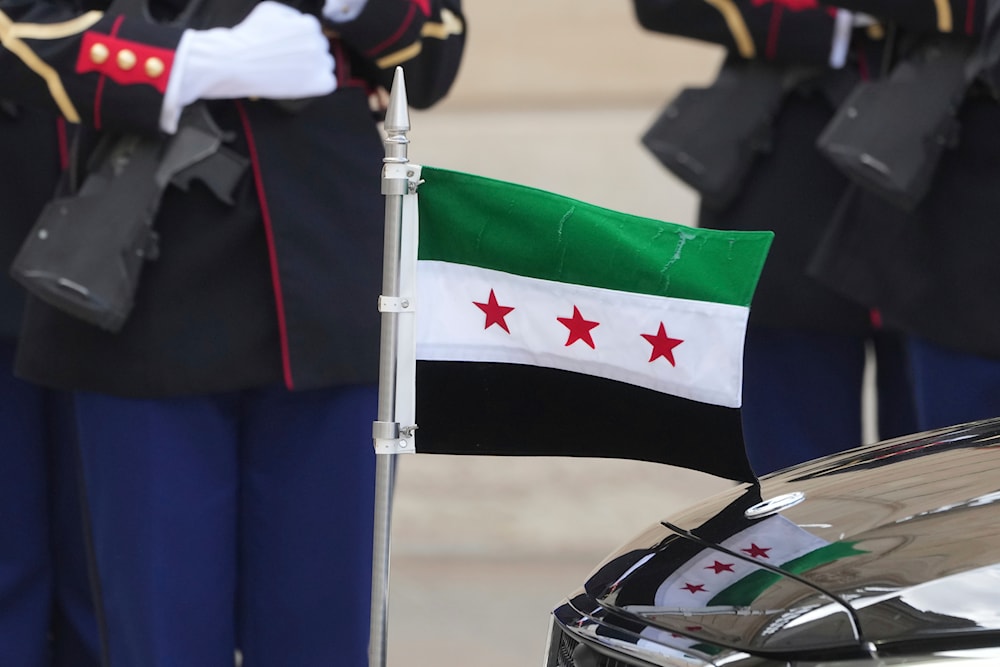 The Syrian flag is pictured as French President Emmanuel Macron welcomes Syria's interim President Ahmad al-Sharaa before their talks Wednesday, May 7, 2025 at the Elysee Palace in Paris. (AP)