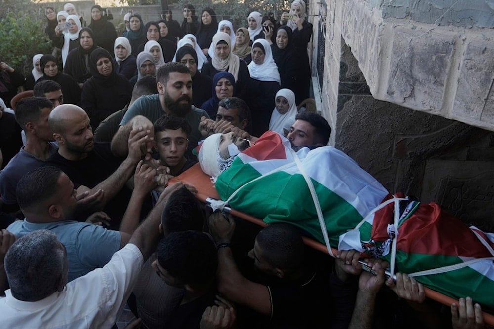 Palestinians carry the body of Abdul Qusay Issa, 23, who was killed in an Israeli military raid, during his funeral at the West Bank village of Salem, near Nablus, Sunday, July 6, 2025 (AP)