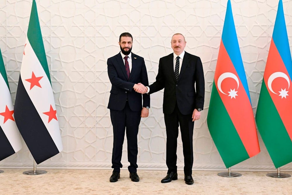 Azerbaijani President Ilham Aliyev, right, and Syria's interim president, Ahmad al-Sharaa pose for a photo prior to their talks in Baku, Azerbaijan, on Saturday, July 12, 2025 (AP)