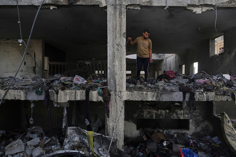 Palestinians inspect the rubble of the Al-Aimawi family's home, destroyed by Israeli airstrikes in Al-Zawaideh, Gaza Strip, on Tuesday, July 1, 2025 (AP)