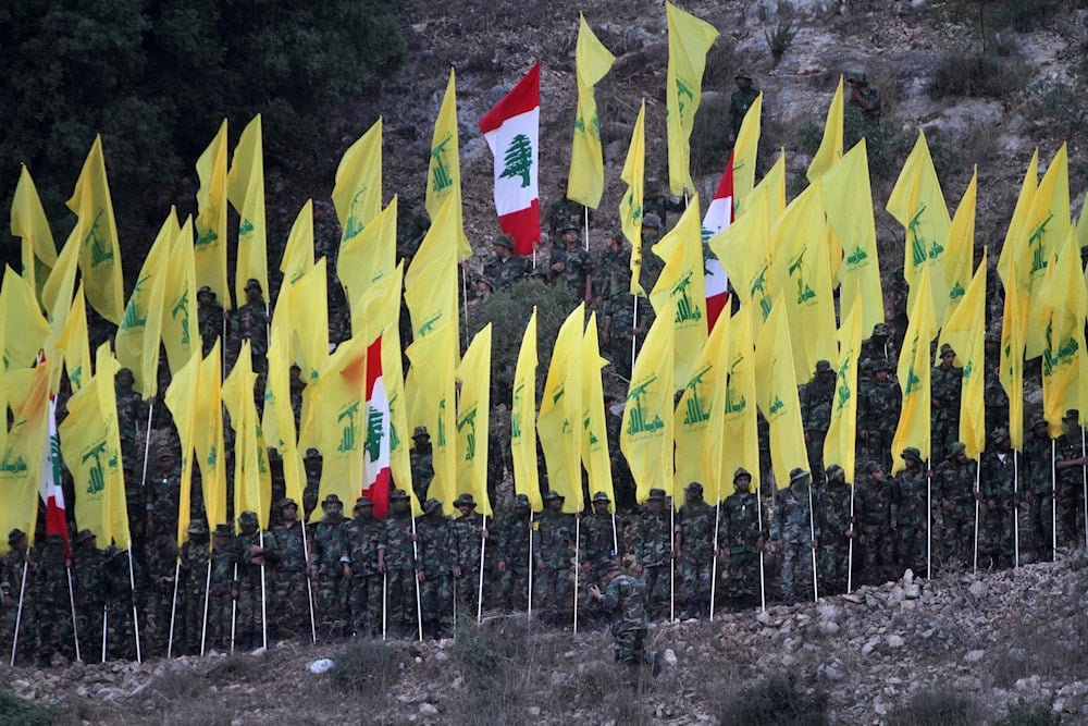Hezbollah fighters hold their group and Lebanese flags, as they perform during a rally marking the ninth anniversary of the 2006 Israel-Hezbollah war, at the southern Lebanese village of Wadi al-Hujair, August 14, 2015, Lebanon (AP)