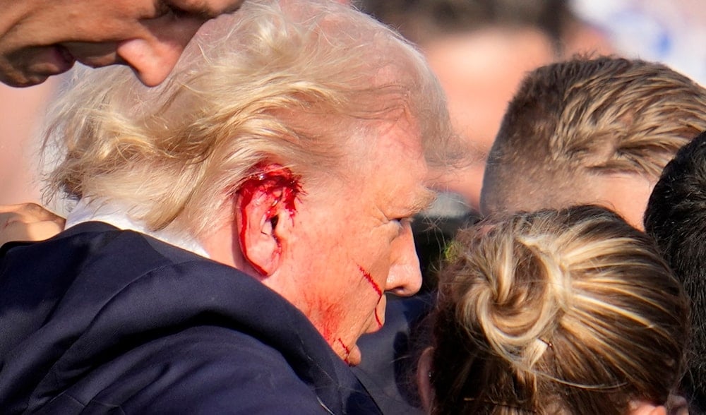 Republican presidential candidate former President Donald Trump is escorted to a motorcade following an attempted assassination at a campaign event in Butler, Pa., on Saturday, July 13, 2024. (AP)