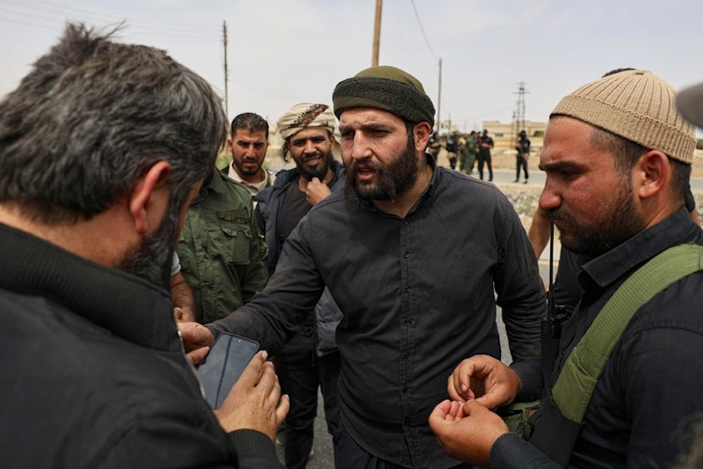Sheikh Laith al-Balous, centre, a Druze leader in the southern Sweida province, speaks with Sweida governor Mustafa al-Bakour, left, at al-Sor al-Kobra village, southern Syria, Thursday, May 1, 2025 (AP)
