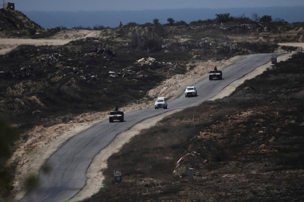 A convoy of Israeli military vehicles leaves the Gaza Strip, seen from southern occupied Palestine, Monday, July 14, 2025 (AP)