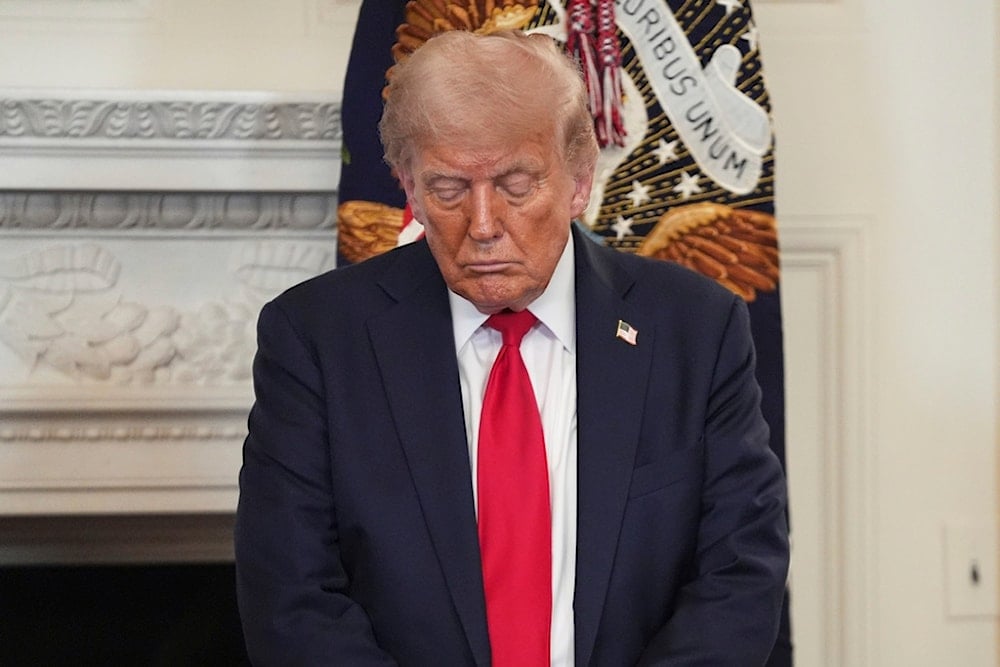President Donald Trump bows his head in prayer during the White House Faith Office luncheon in the State Dining Room, Monday, July 14, 2025, in Washington (AP Photo/Evan Vucci)