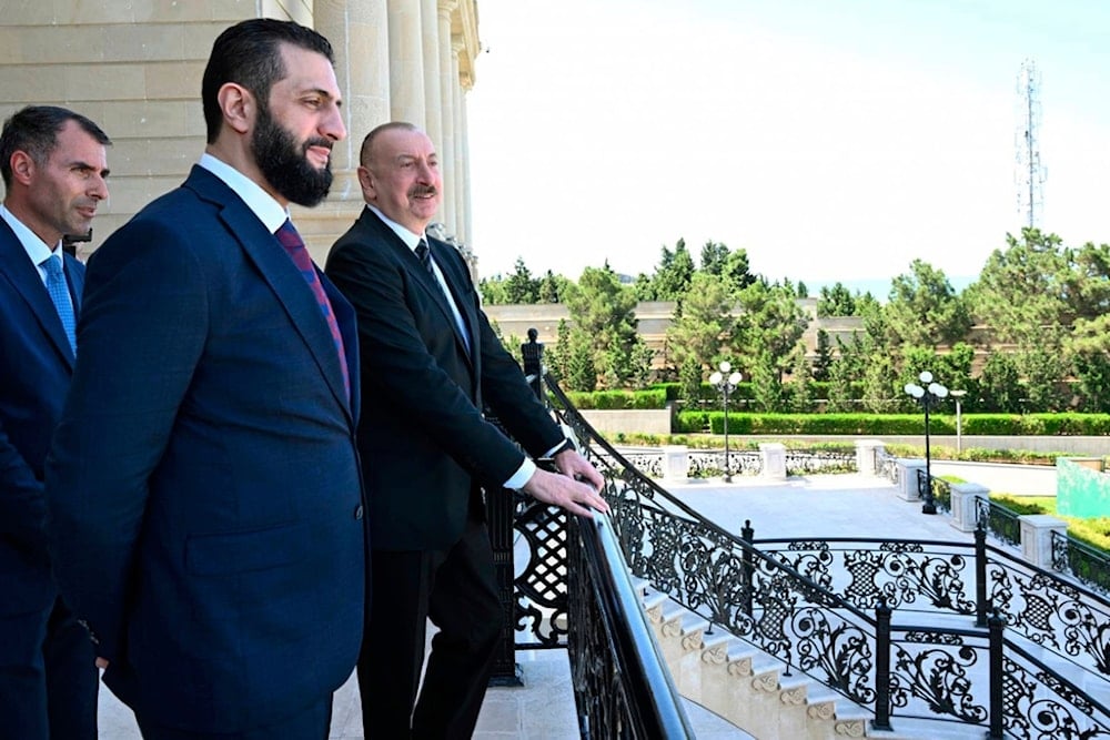 Azerbaijani President Ilham Aliyev, right, and Syria's interim president, Ahmad al-Sharaa, second left, stand on the balcony during their meeting in Baku, Azerbaijan, on Saturday, July 12, 2025 (Azerbaijani Presidential Press Office via AP)