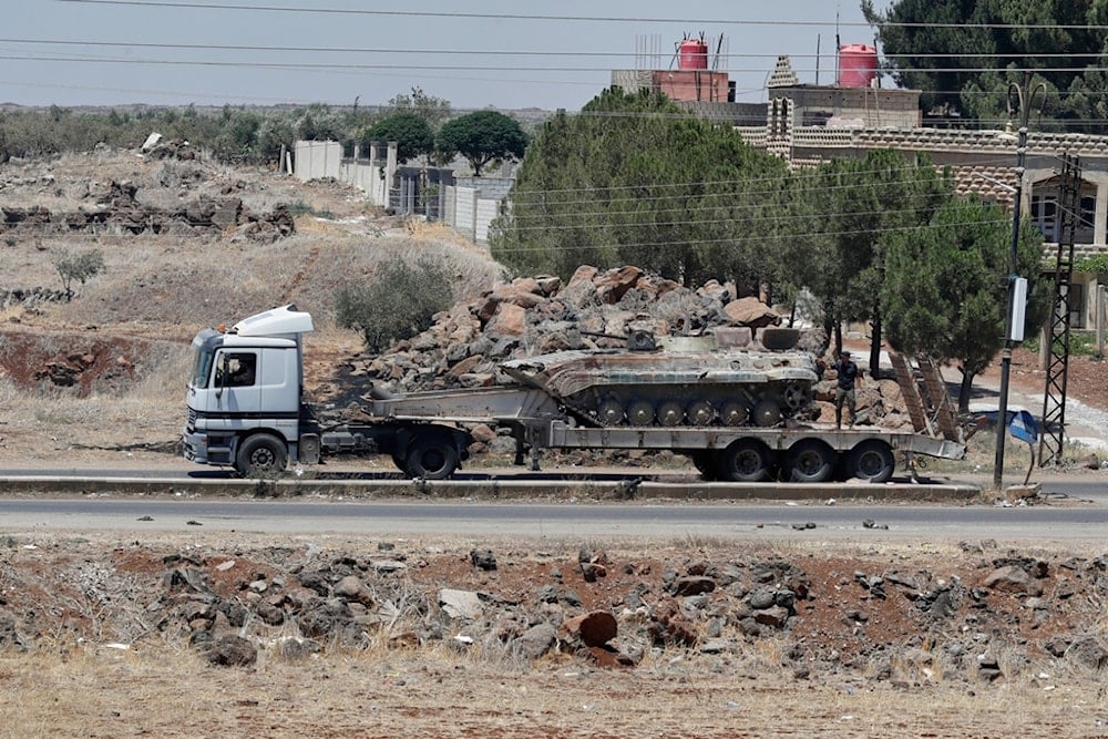A tank for the Syrian government forces carried on a truck, which withdrew from Sweida city, passed at Mazraa village, southern Syria, Tuesday, July 15, 2025 (AP)