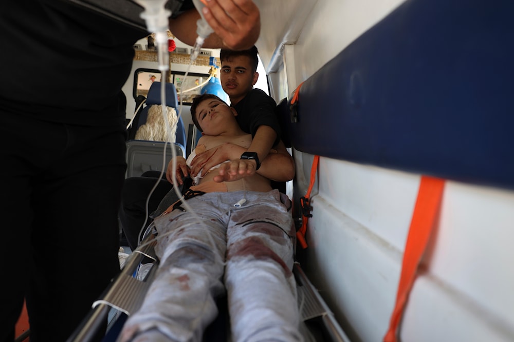 A boy who was injured in Sweida city during clashes between the Syrian government forces and Druze militias, lies inside an ambulance in Busra al-Harir village, southern Syria, Tuesday, July 15, 2025. (AP)
