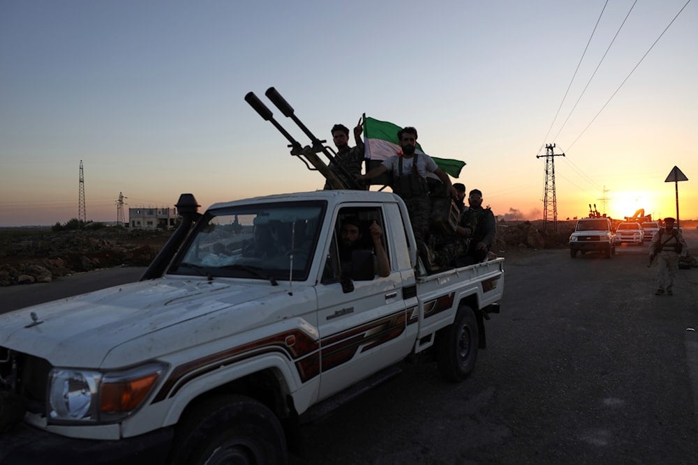 A convoy of government forces drives toward Sweida city where clashes erupted between government troops and Druze militias as it passes through Mazraa village in southern Syria, Tuesday, July 15, 2025. (AP)