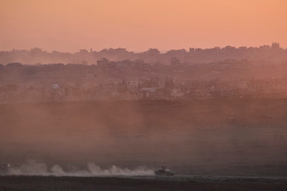 An Israeli occupation forces vehicle moves in the Gaza Strip as seen from southern occupied Palestine on Sunday, July 6, 2025 (AP)